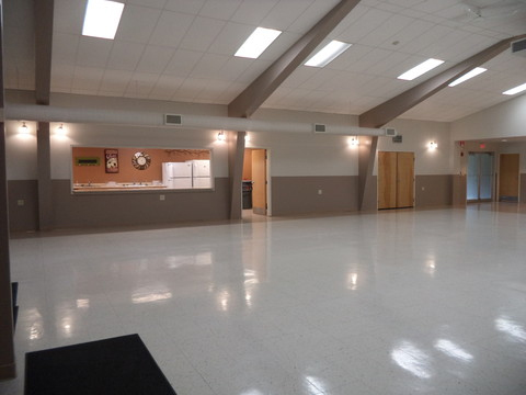 Community center empty auditorium showing counter with view into kitchen