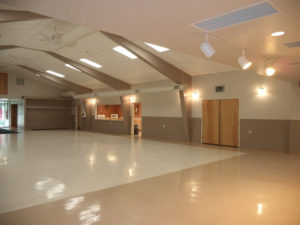 Large Community Center Auditorium with overhead lighting
