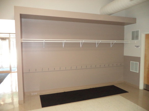 Community Center closet with hooks and rack for hanging, displayed empty