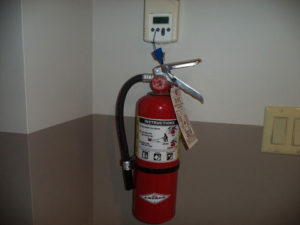 Fire extinguisher hanging on a wall in Community Center
