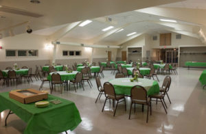 Community center with decorated tables and cake with plates