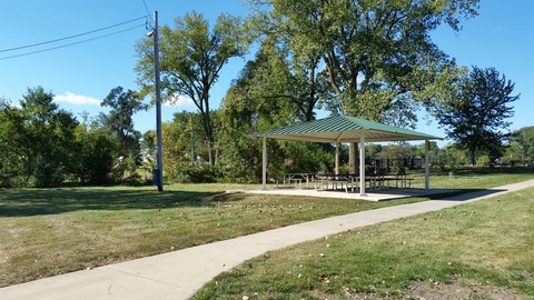Lake Park Picnic Shelter with paved trail leading past shelter