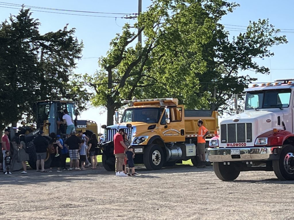 photo of people looking at vehicles at a Touch a Truck event