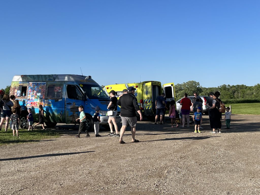 photo of people veiwing vehicles at a Touch a Truck event