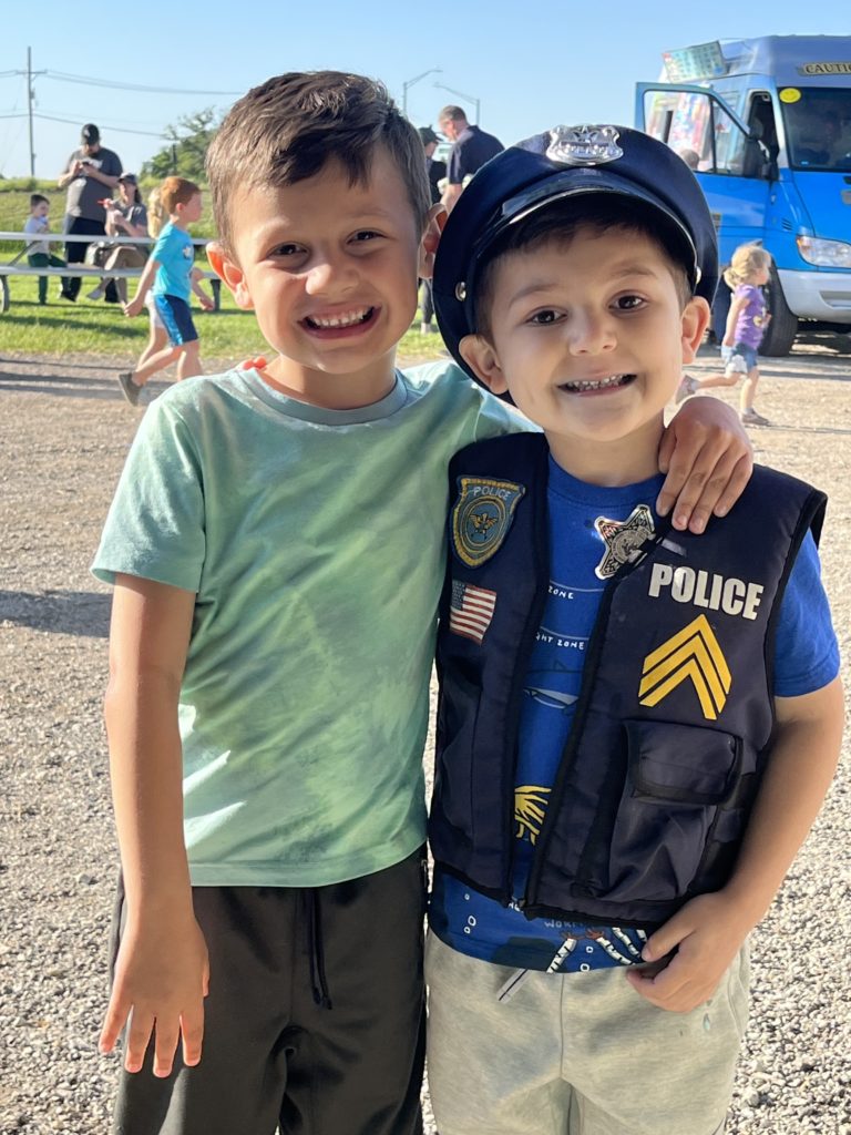 picture of two children at a Touch a Truck event