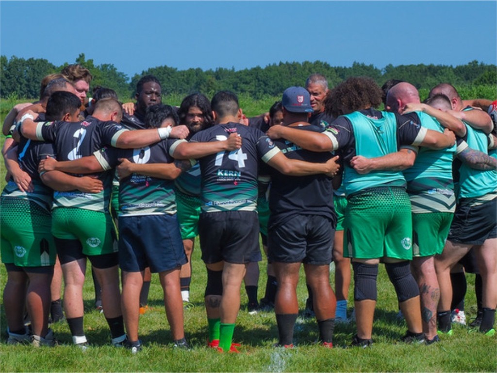 ruby players standing in a circle for a pre game meeting