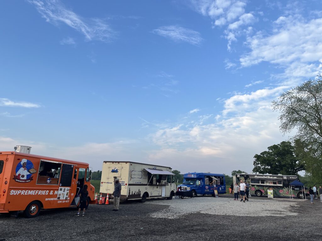 different food trucks parked in a row for a food truck night